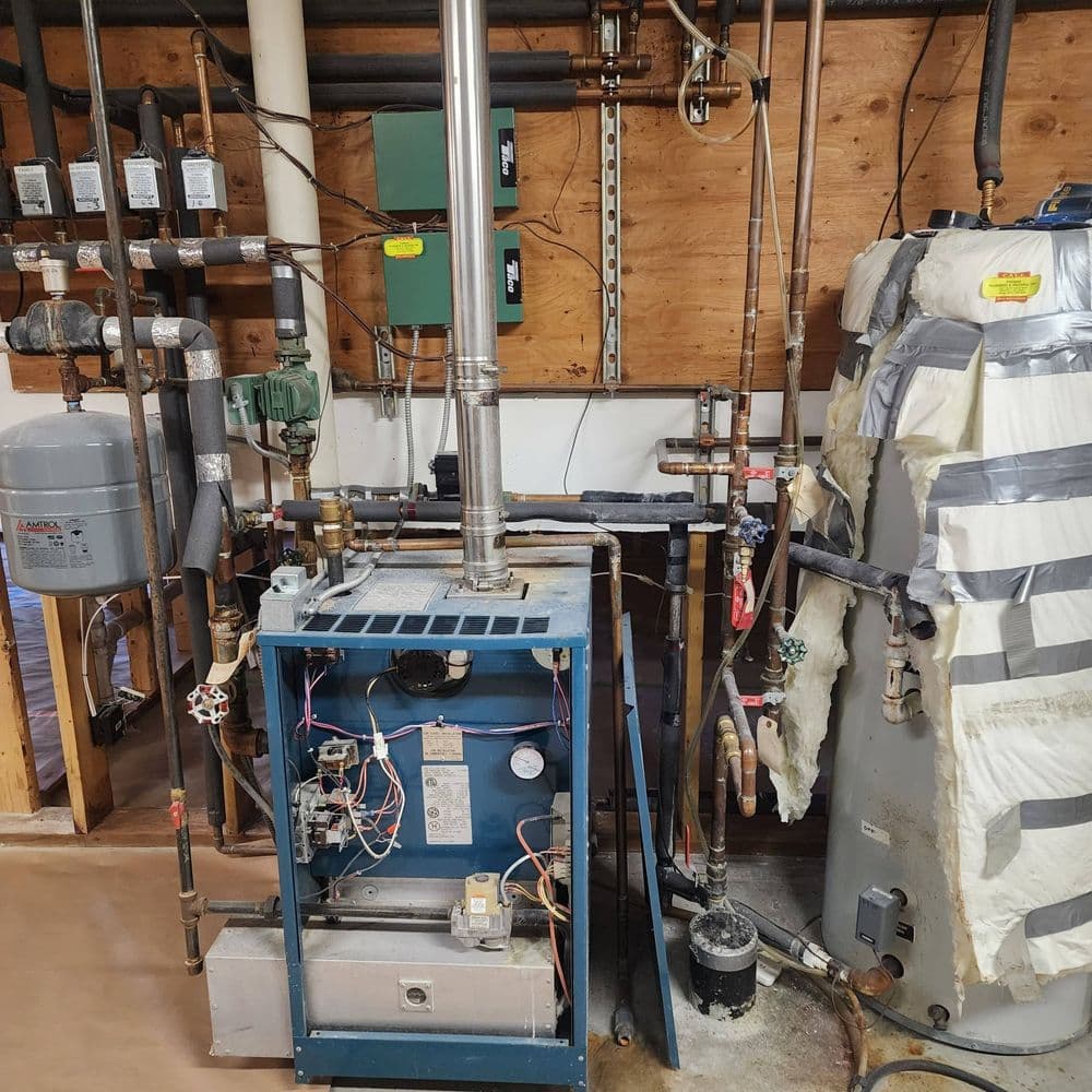 Home heating system with furnace, water heater, and plumbing infrastructure.